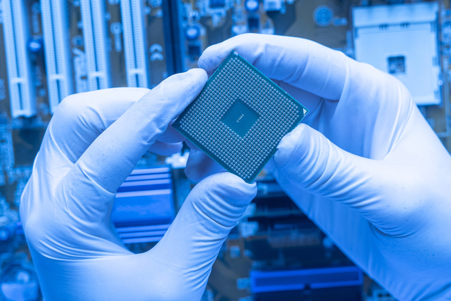 close-up-scientist-hand-holding-cpu-processor-chip-working-laboratory
